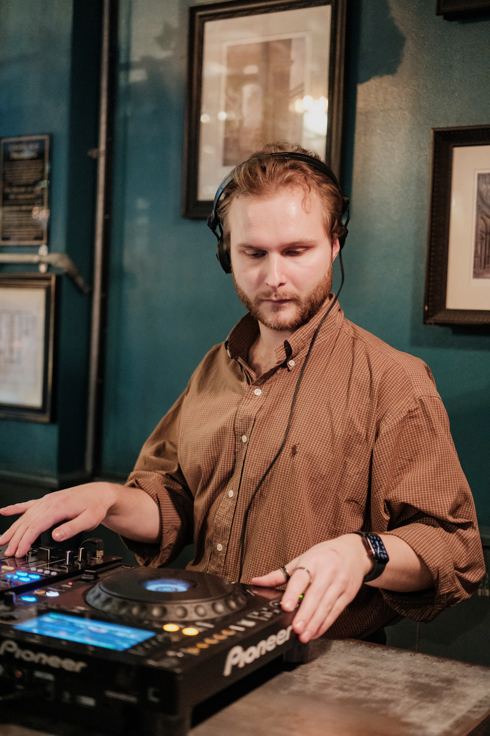 Audio technician managing sound equipment in vibrant Cellar Bar event space.