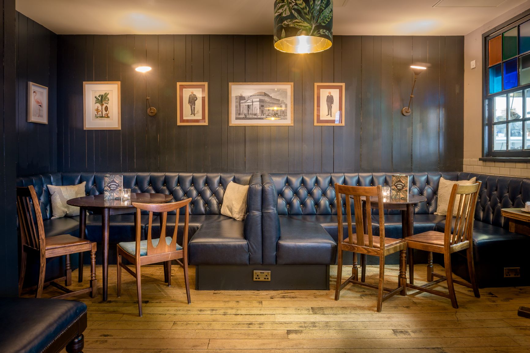 Cozy library venue with dark wood paneling for intimate meetings and small events.