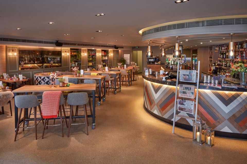 Modern event venue with stylish seating and ambient lighting for meetings.