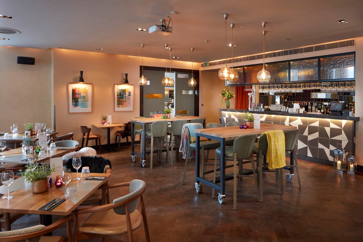 Modern restaurant venue with warm lighting for intimate meetings and events.