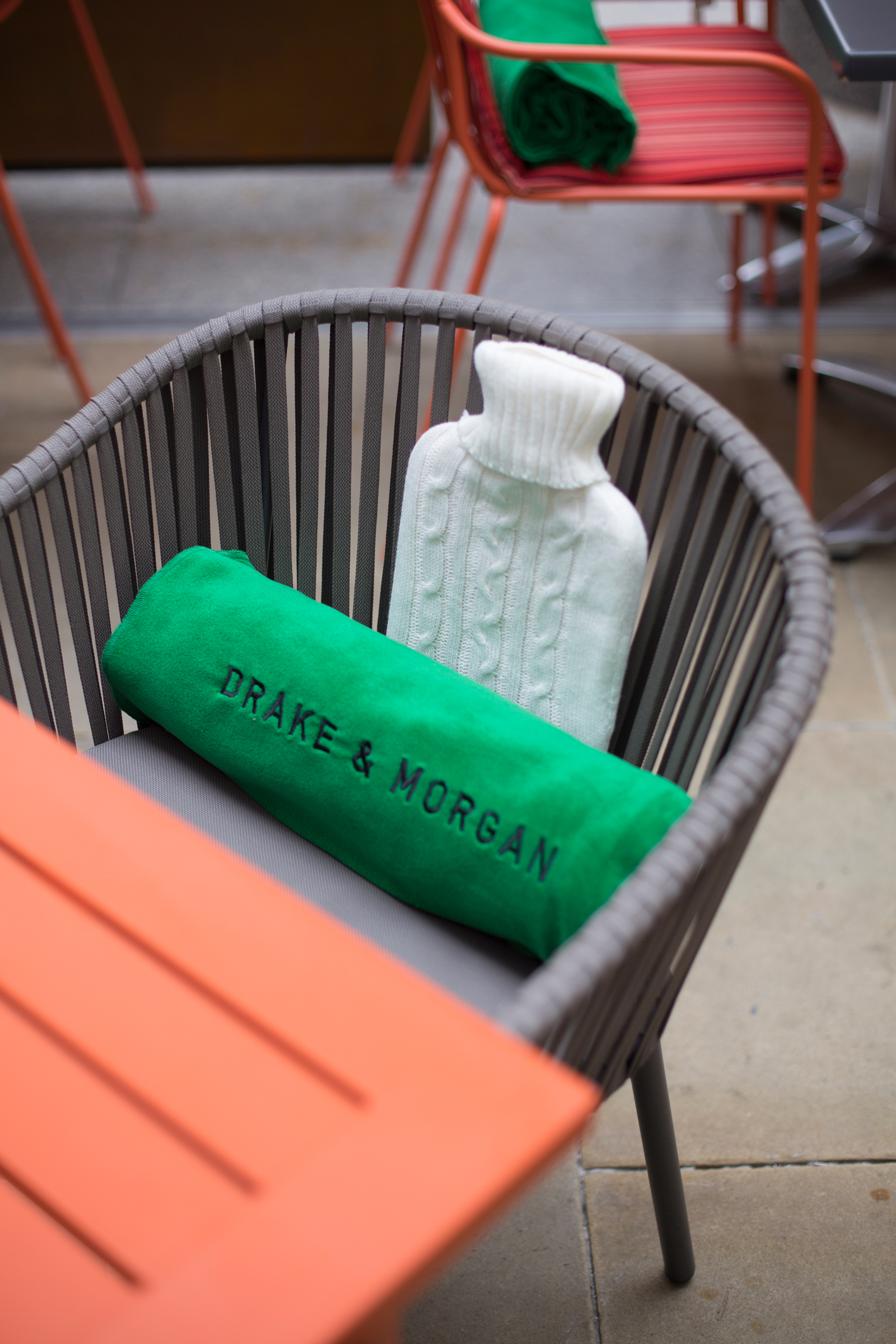 Cozy outdoor event setup with green blanket and hot water bottle at The Happenstance.
