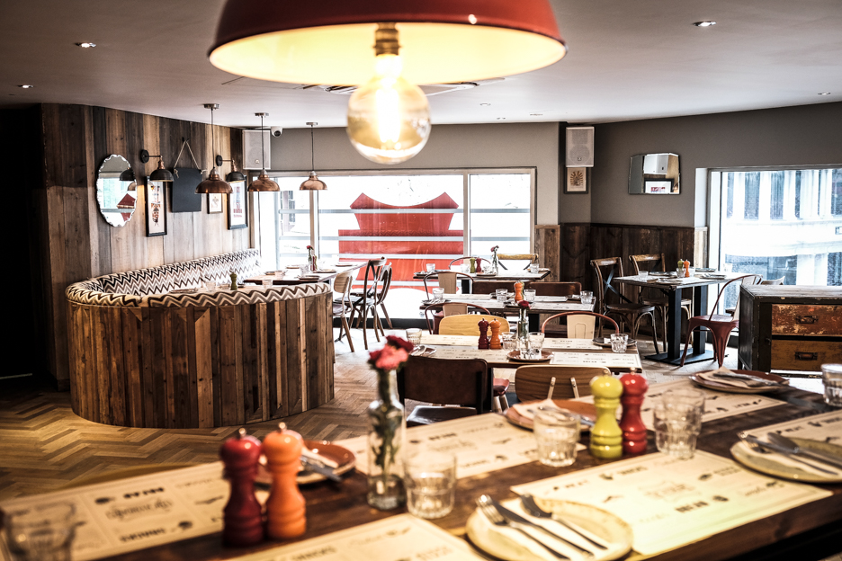 Stylish restaurant mezzanine with warm wood accents, perfect for intimate events and meetings.