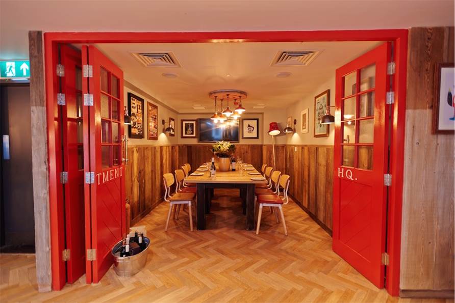 Stylish meeting space with red doors, ideal for team-building and brainstorming events.