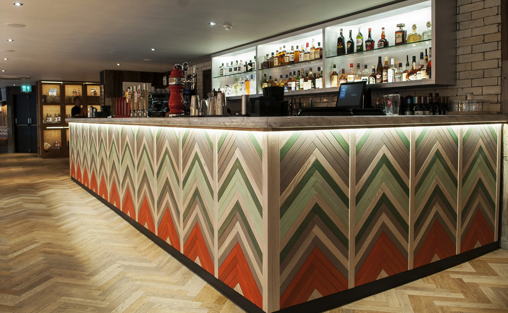 Stylish bar with chevron design, perfect for networking events and cocktail receptions.