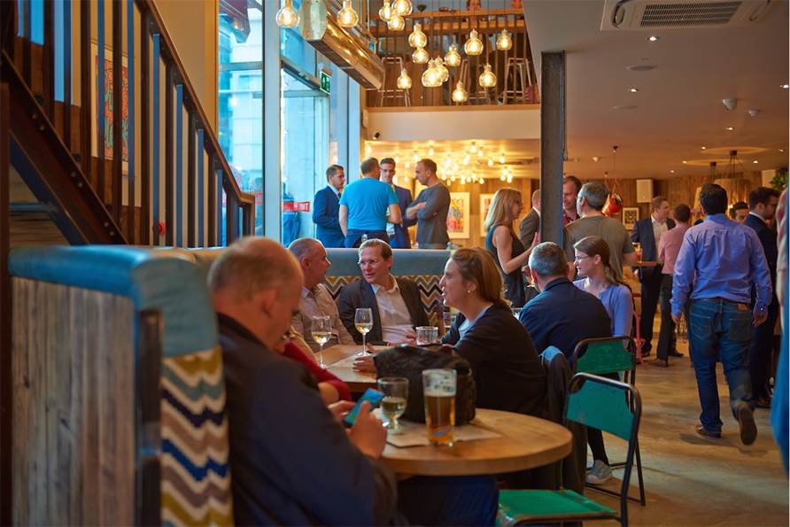 Vibrant networking event at The Hydrant with modern decor and casual seating.