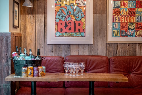 Cozy event space at The Hydrant with rustic backdrop, perfect for gatherings and networking.