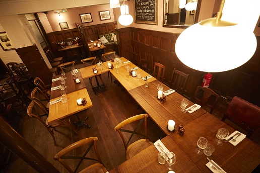 Intimate dining space in The Holly Bush, perfect for meetings and events.