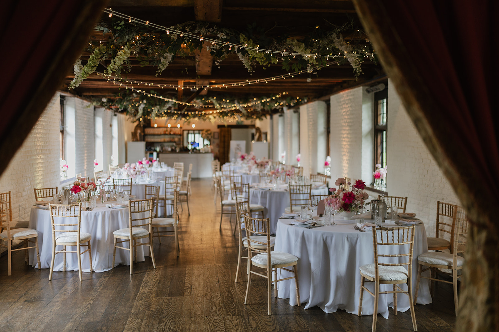 Elegant Tudor Barn Eltham venue with round tables, perfect for weddings and upscale events.