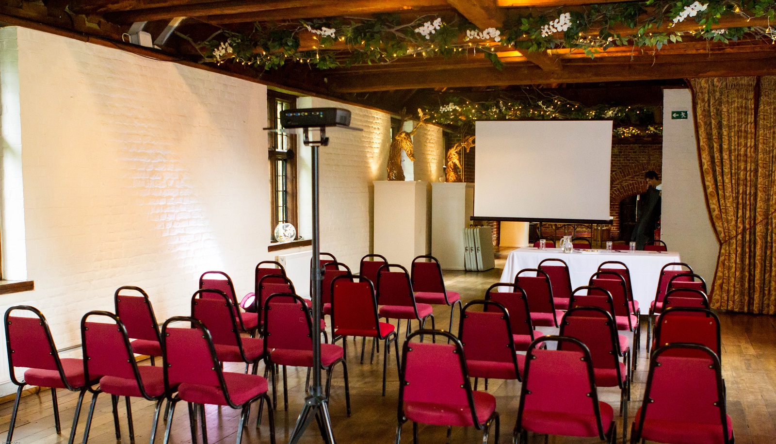 Tudor Barn Eltham meeting space with red chairs, perfect for workshops and seminars.