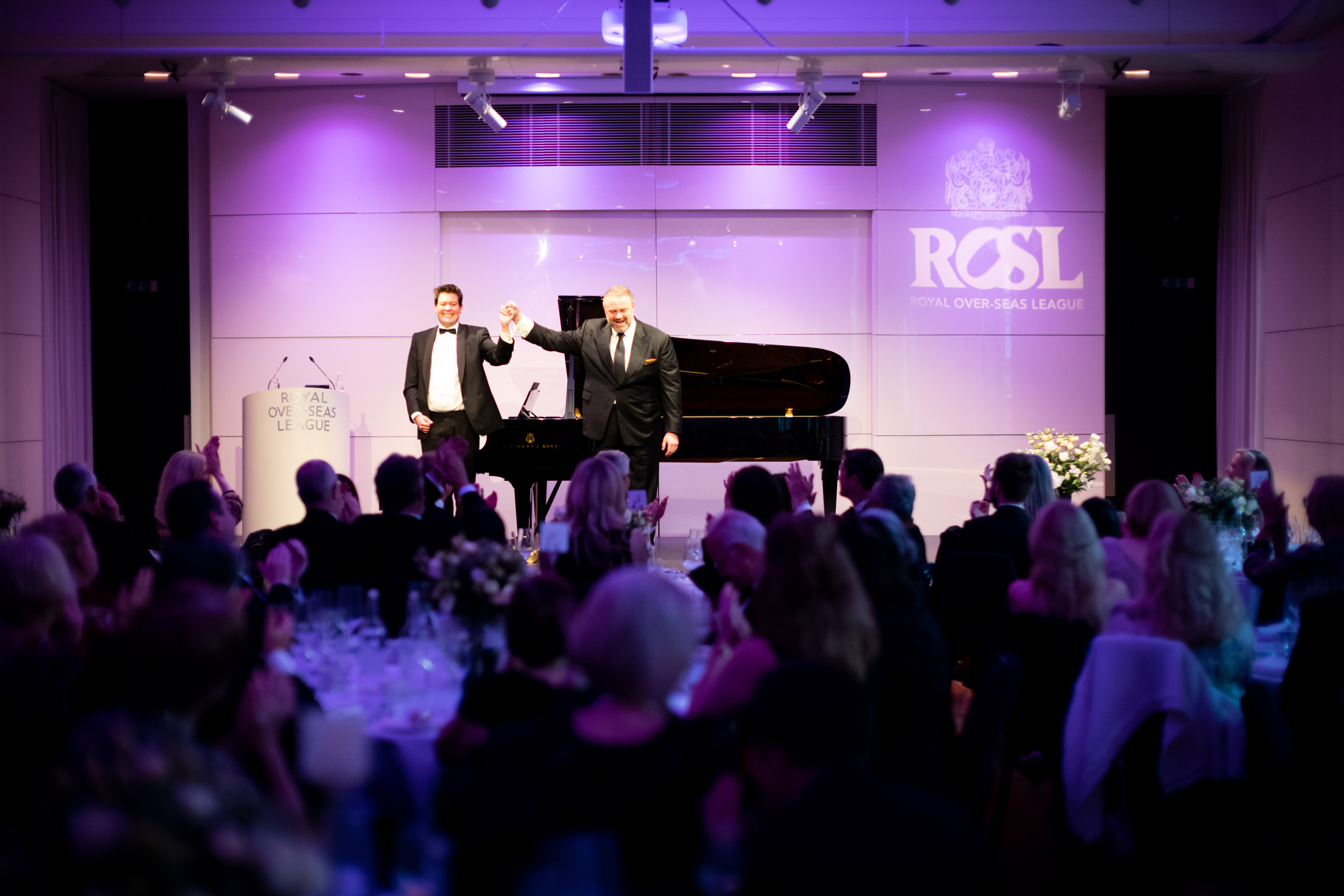 Princess Alexandra Hall event with live performance, grand piano, and engaged audience.