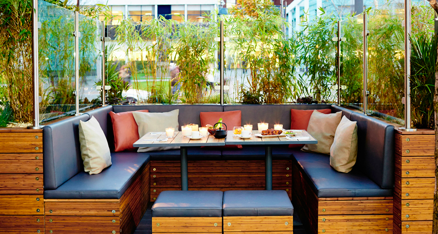 Cozy outdoor seating at Zouk Tea Bar & Grill, perfect for networking events and gatherings.