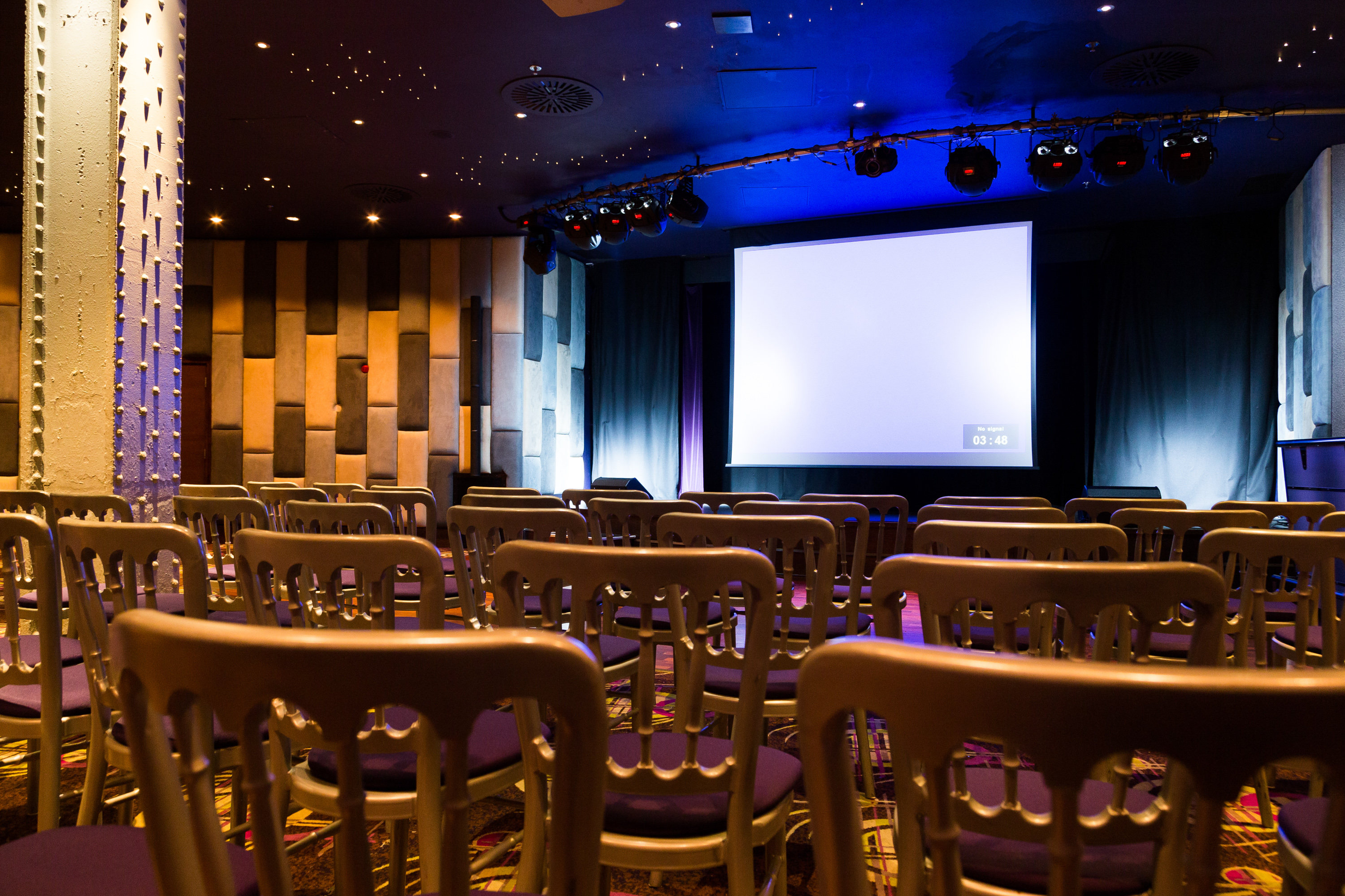 Private Events Suite in Manchester 235 with chairs and projection screen for conferences.