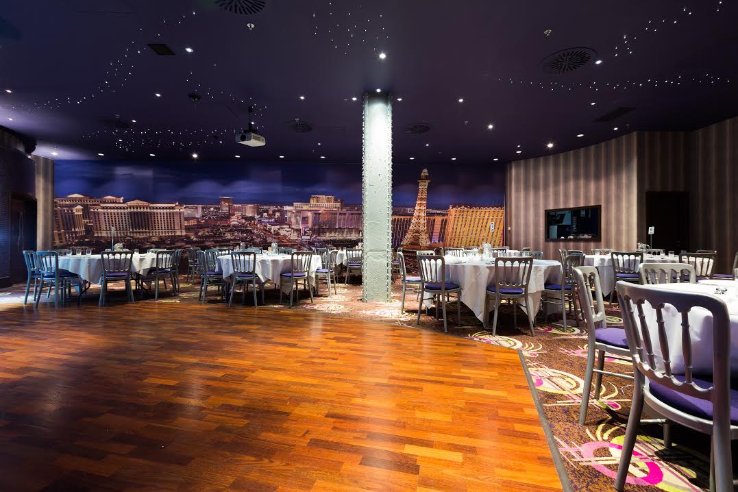Stylish Private Events Suite in Manchester 235 with elegant round tables for corporate gatherings.