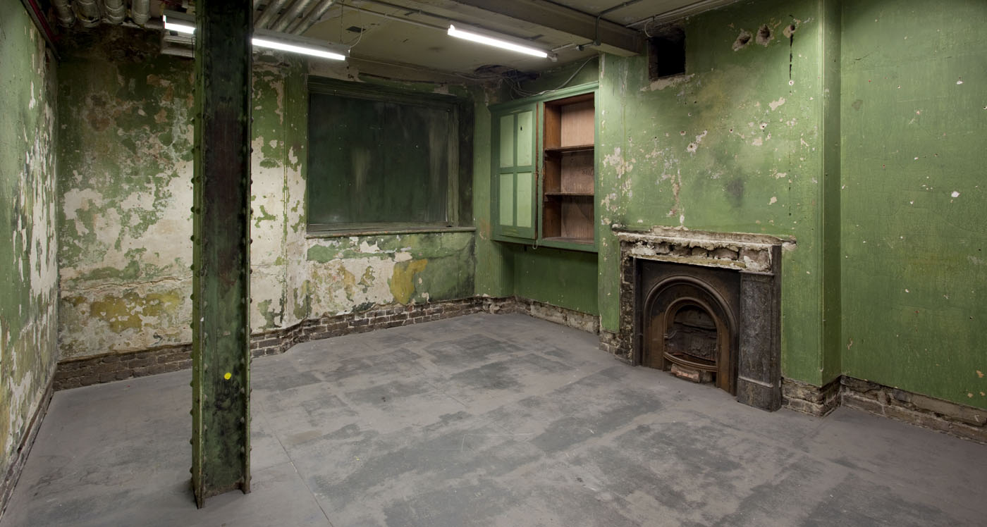 Raw event space with peeling green paint at Shoreditch Town Hall for unique gatherings.