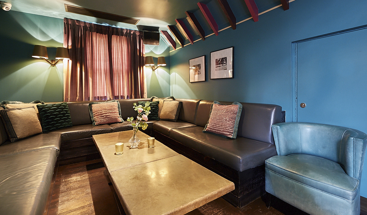 Cozy Penthouse Champagne Bar with plush seating for intimate meetings and workshops.
