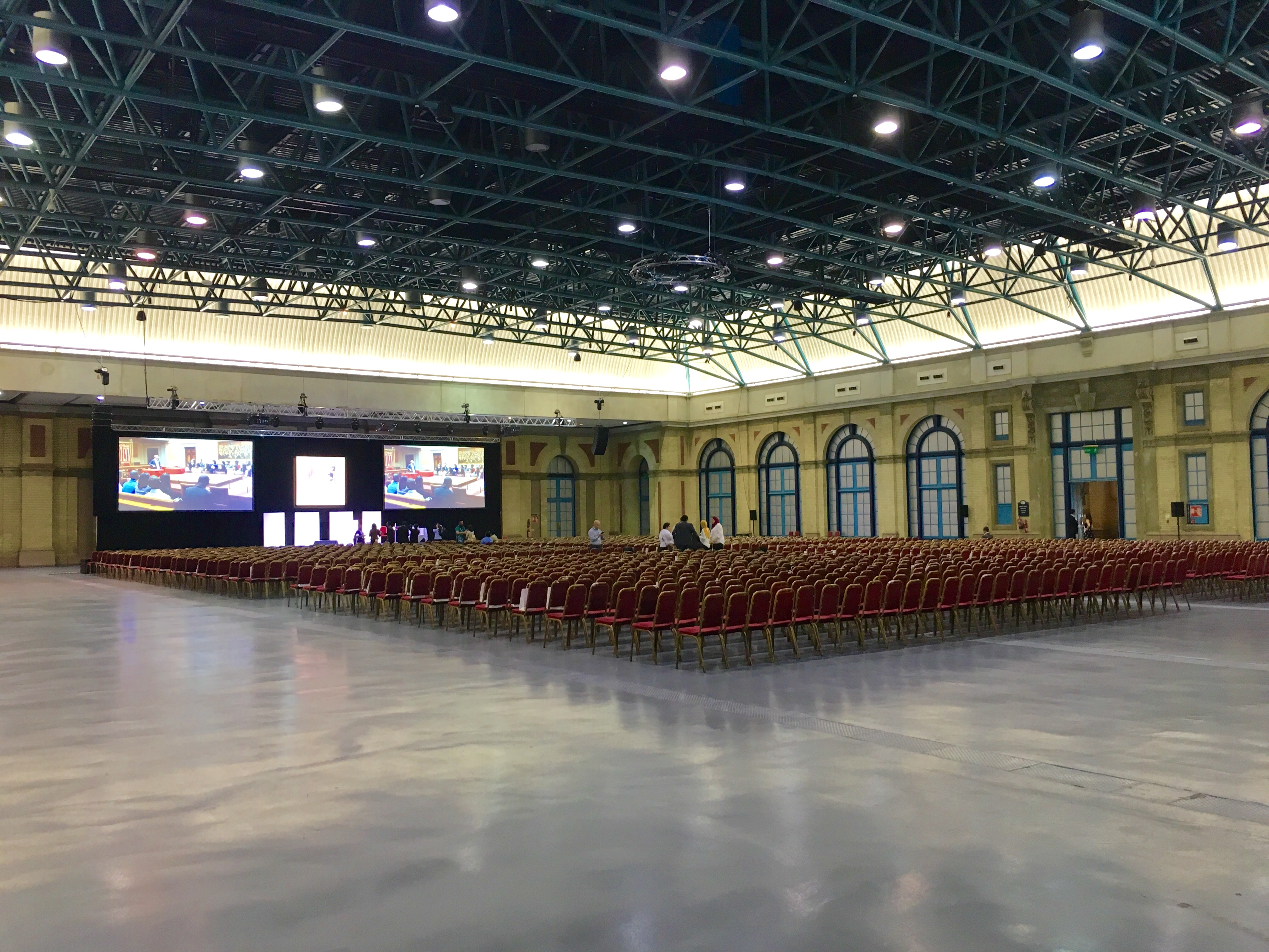 West Hall at Alexandra Palace, spacious conference venue with high ceilings and stage.