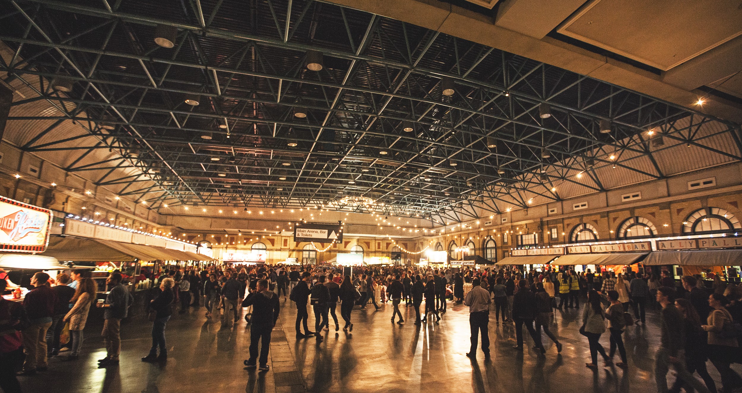 West Hall at Alexandra Palace, bustling event space with high ceilings for exhibitions and galas.