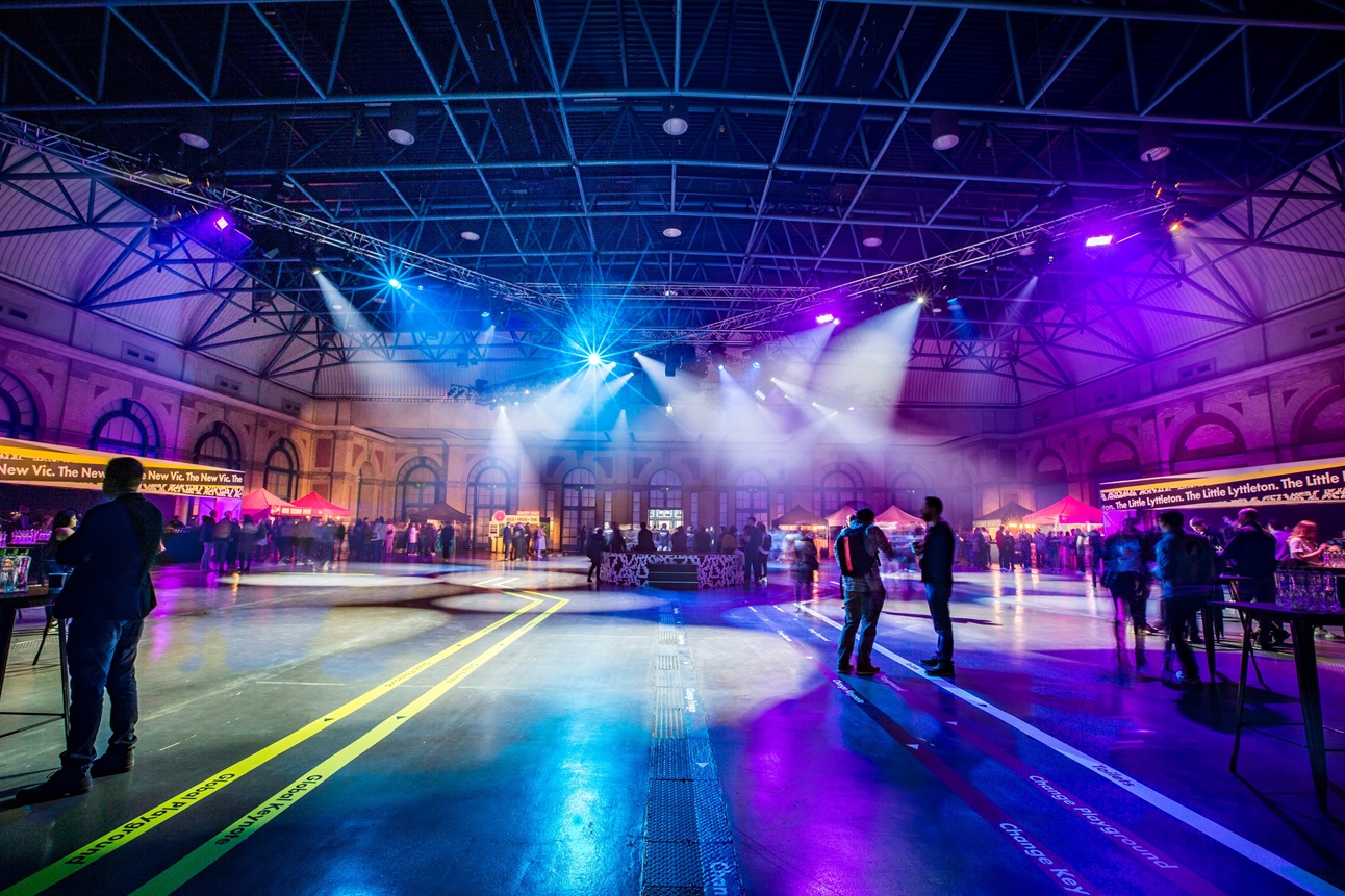 "West Hall at Alexandra Palace: vibrant event space with dynamic lighting for networking."