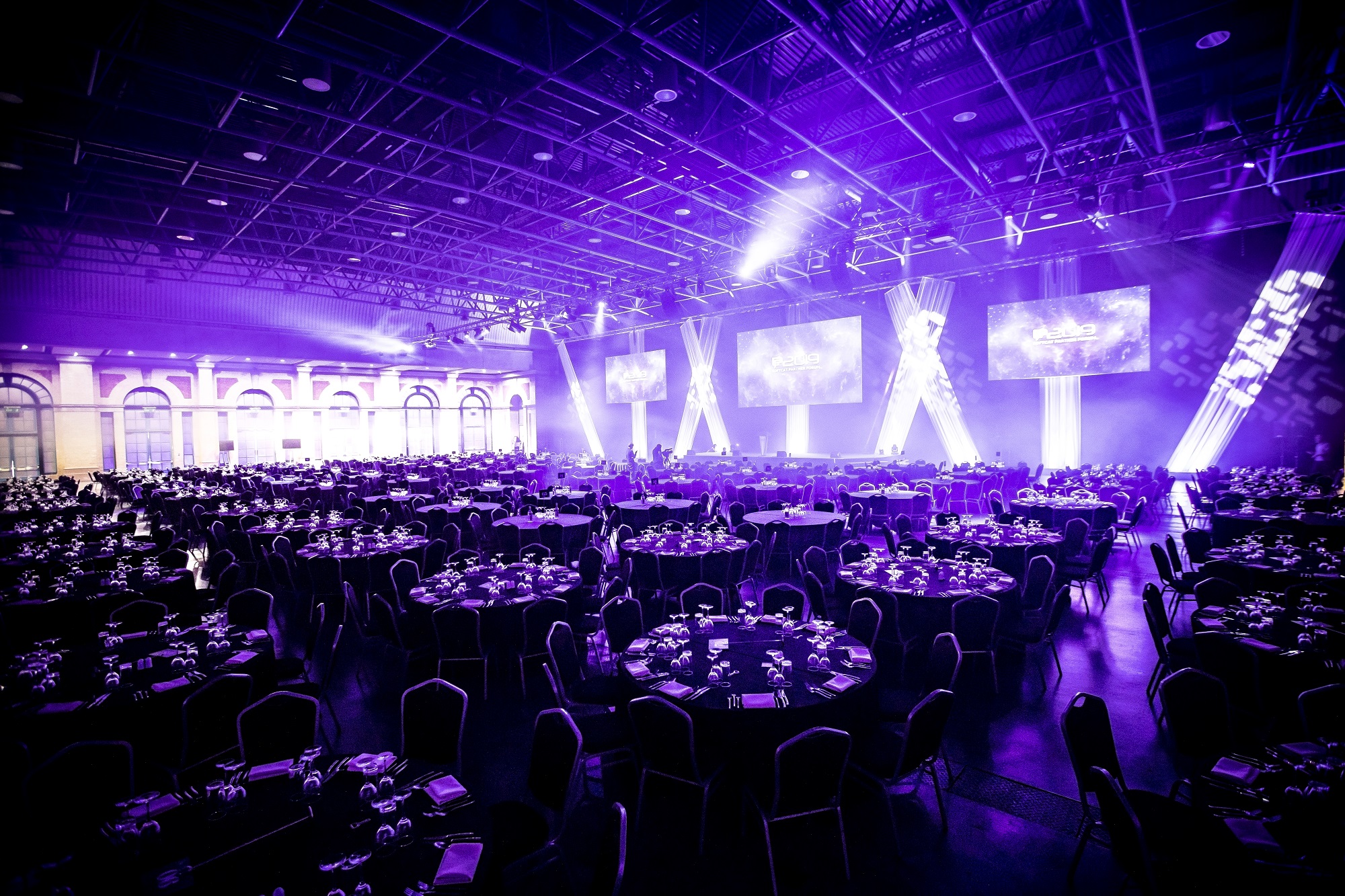 West Hall at Alexandra Palace set for a formal corporate event with elegant dining.