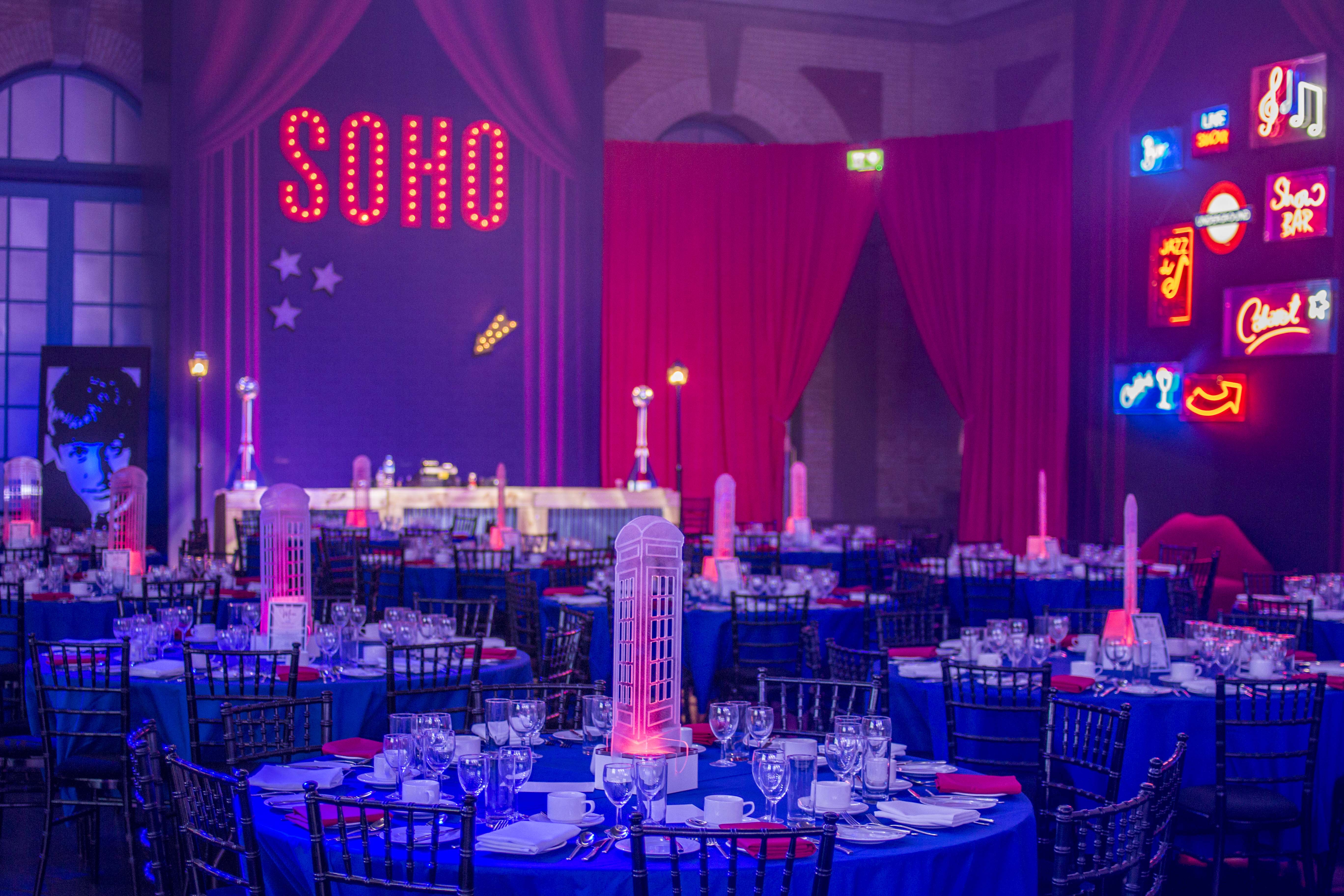 West Hall at Alexandra Palace, vibrant gala space with neon lights and elegant decor.