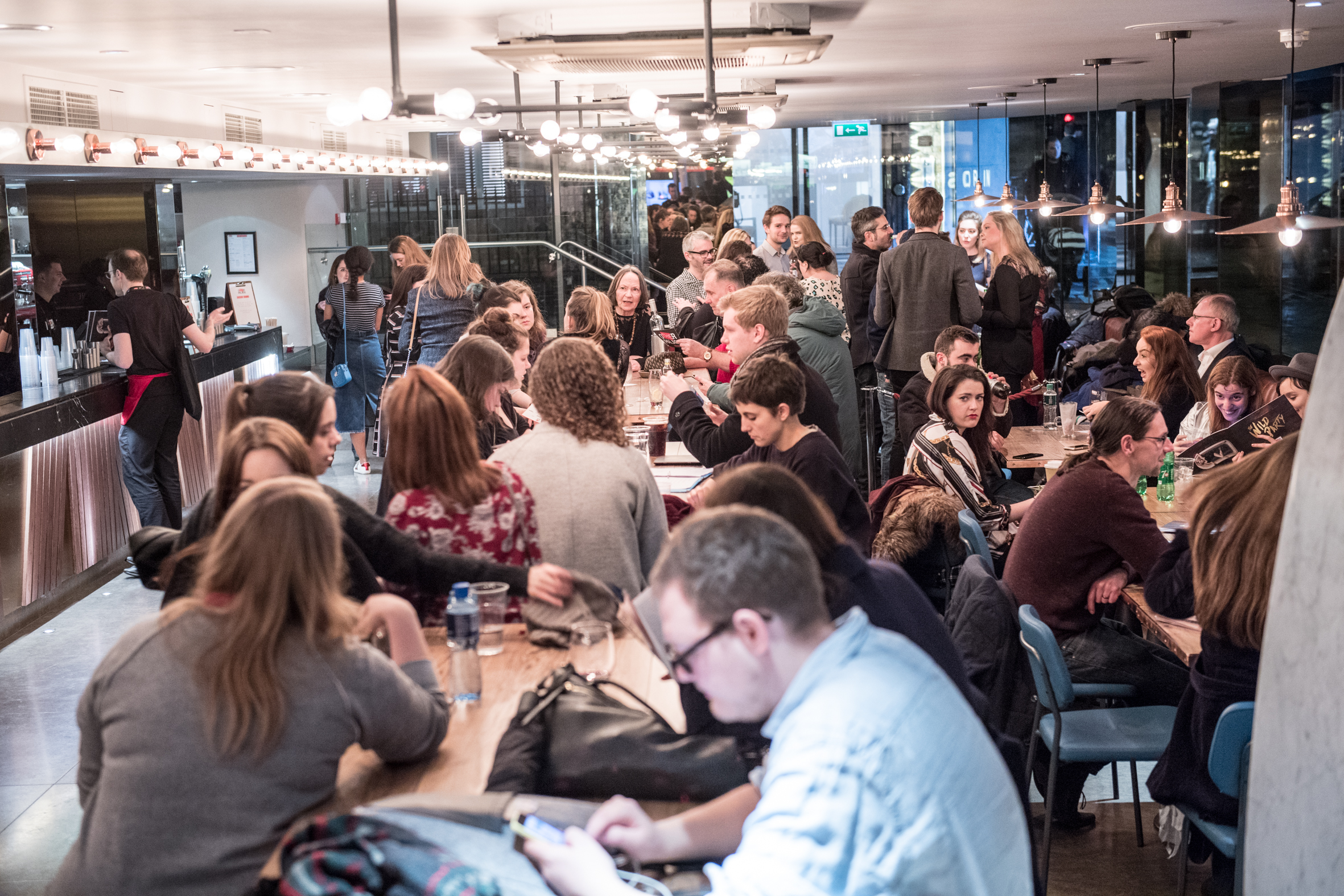 Vibrant networking event at The Other Palace Theatre with modern decor and lively atmosphere.