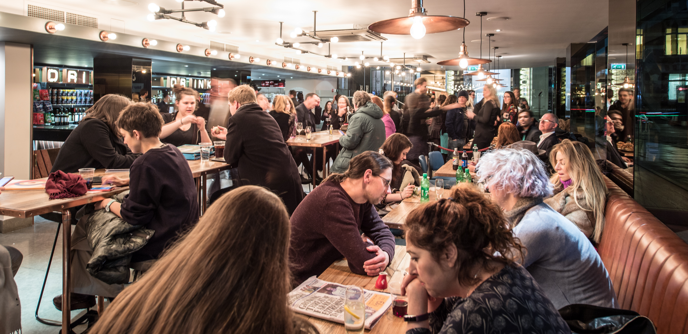 Social event at The Other Palace Theatre with warm lighting and networking guests.
