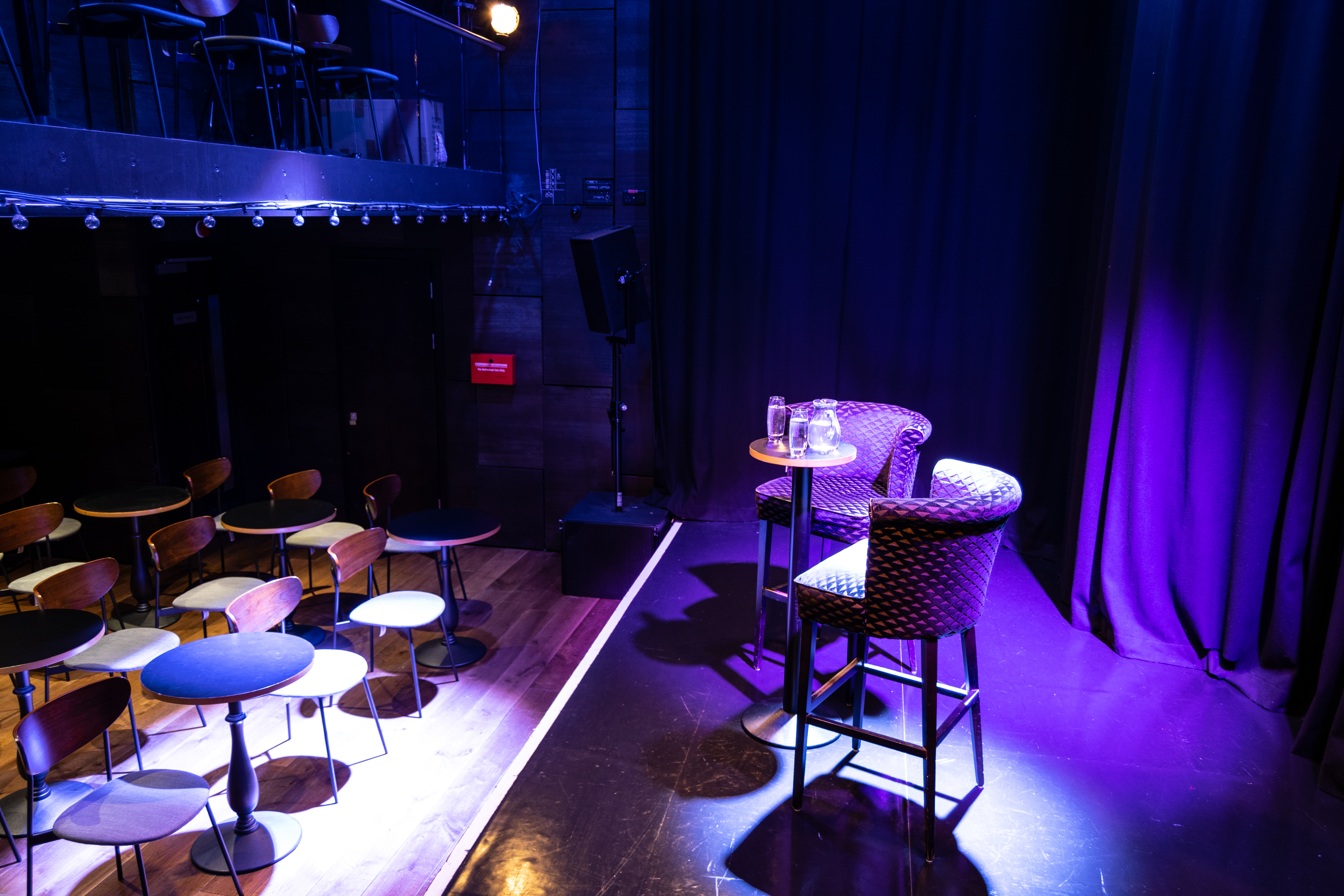 Intimate event space at The Other Palace Theatre with stage and chairs for discussions.