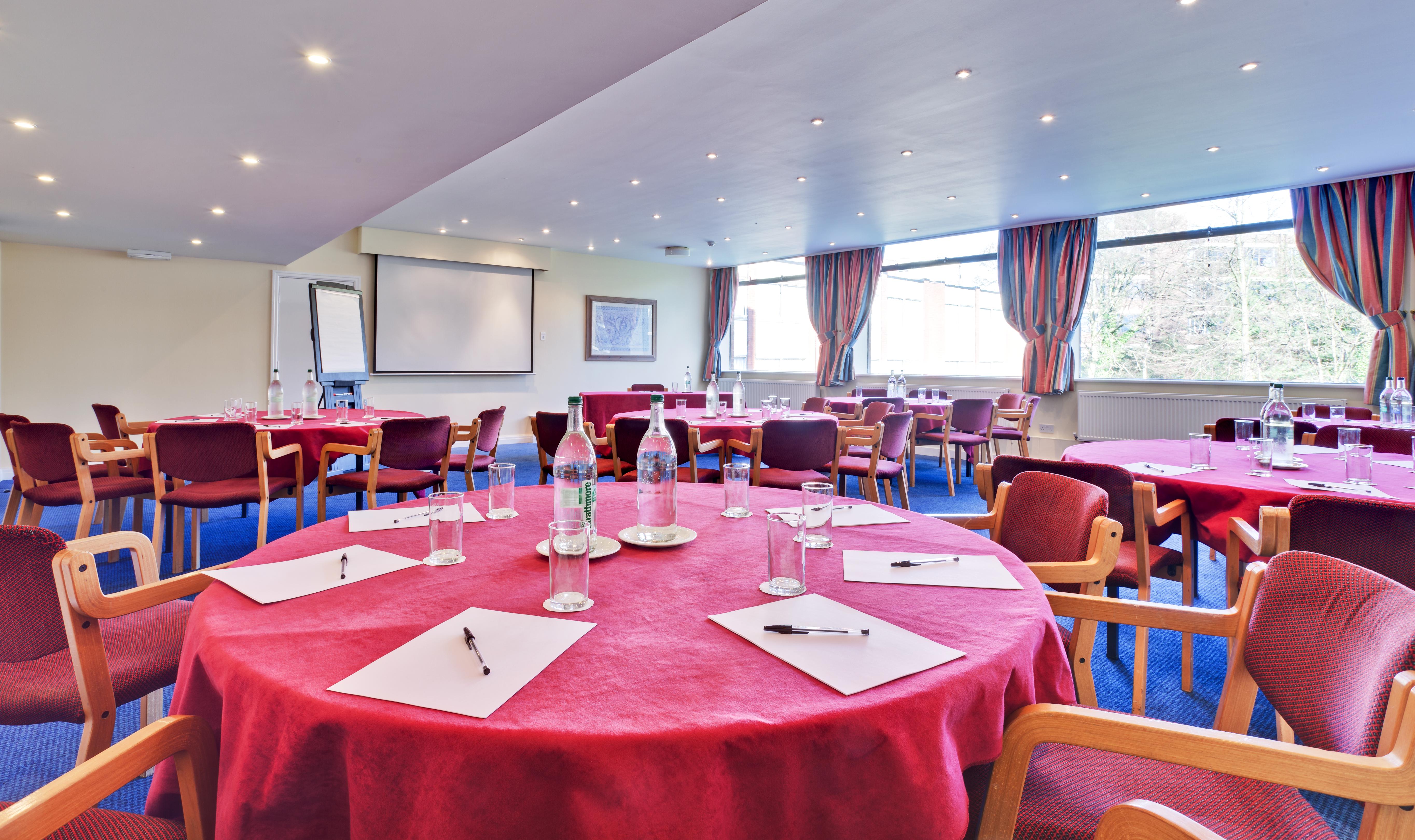 Calthorpe Suite meeting space with round tables, ideal for workshops and events.