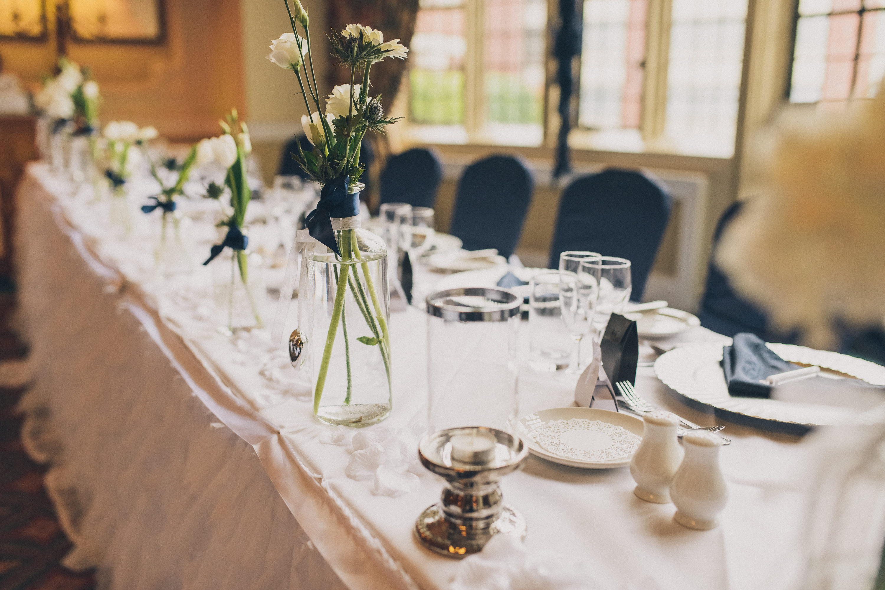Elegant banquet table with floral centerpieces at Best Western Plough and Harrow Hotel.