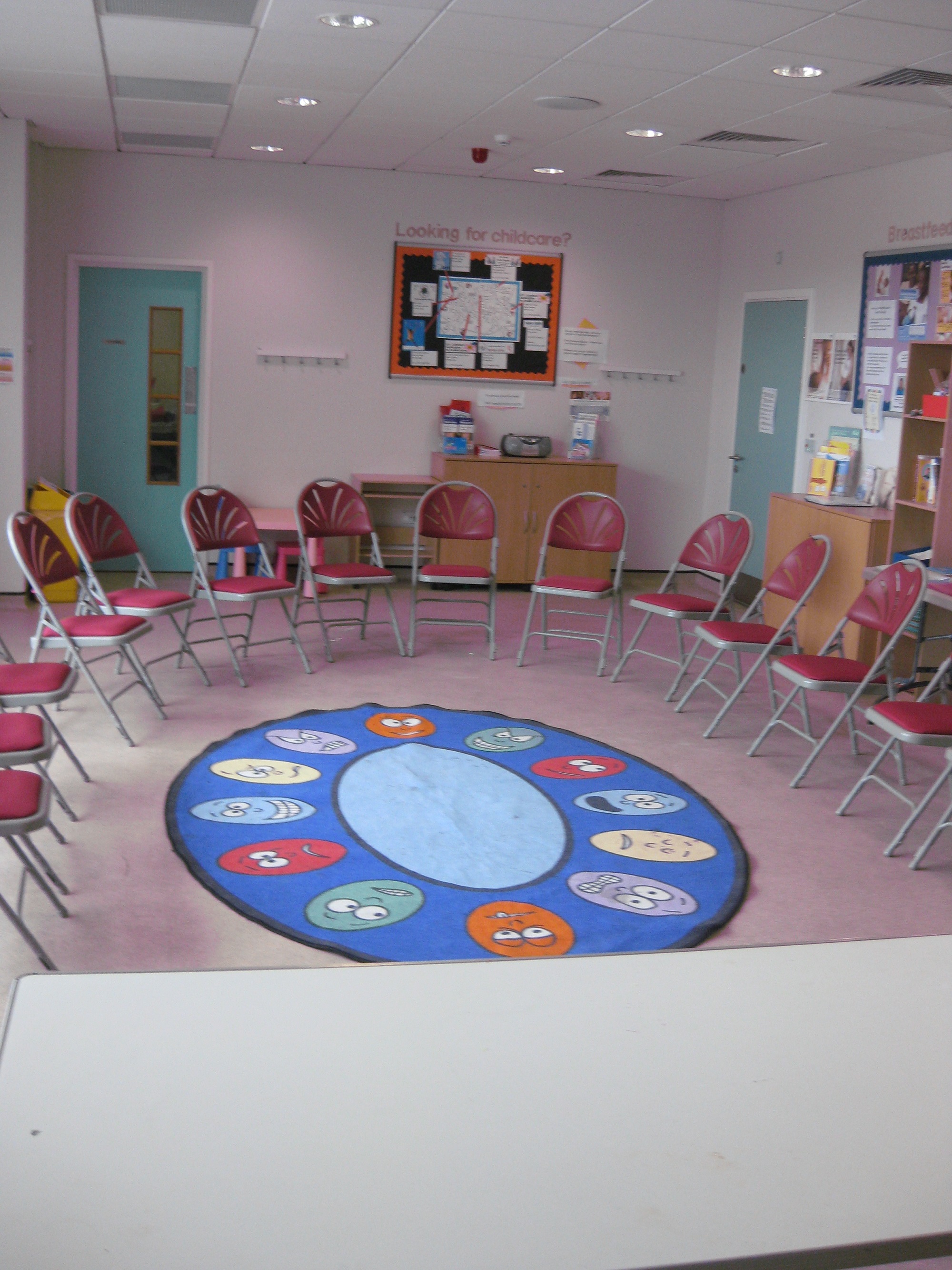 Community Room at Furzefield Children's Centre with red chairs for workshops and meetings.