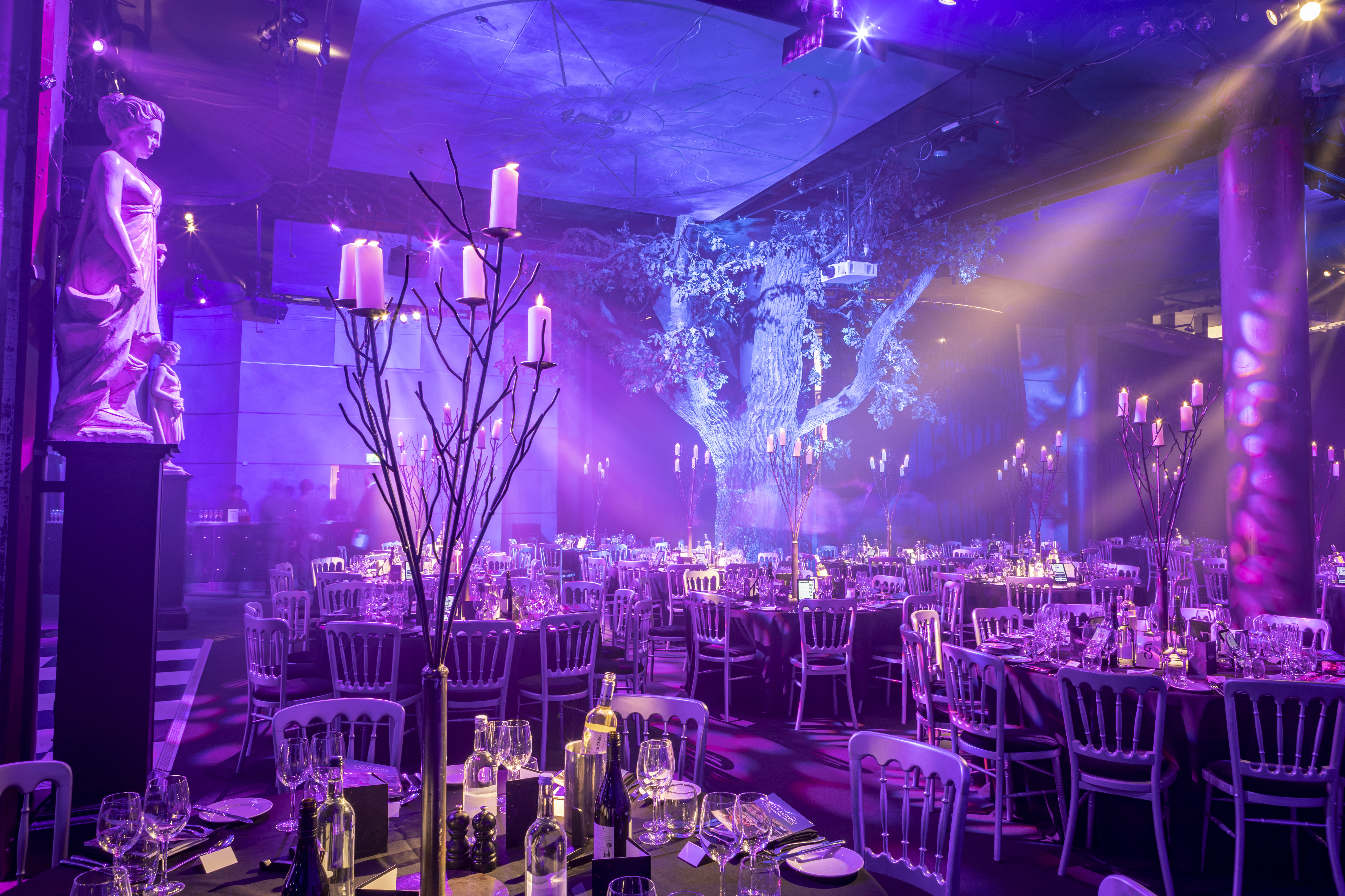 Elegant event space at Underglobe, featuring fine dining and dramatic purple lighting.