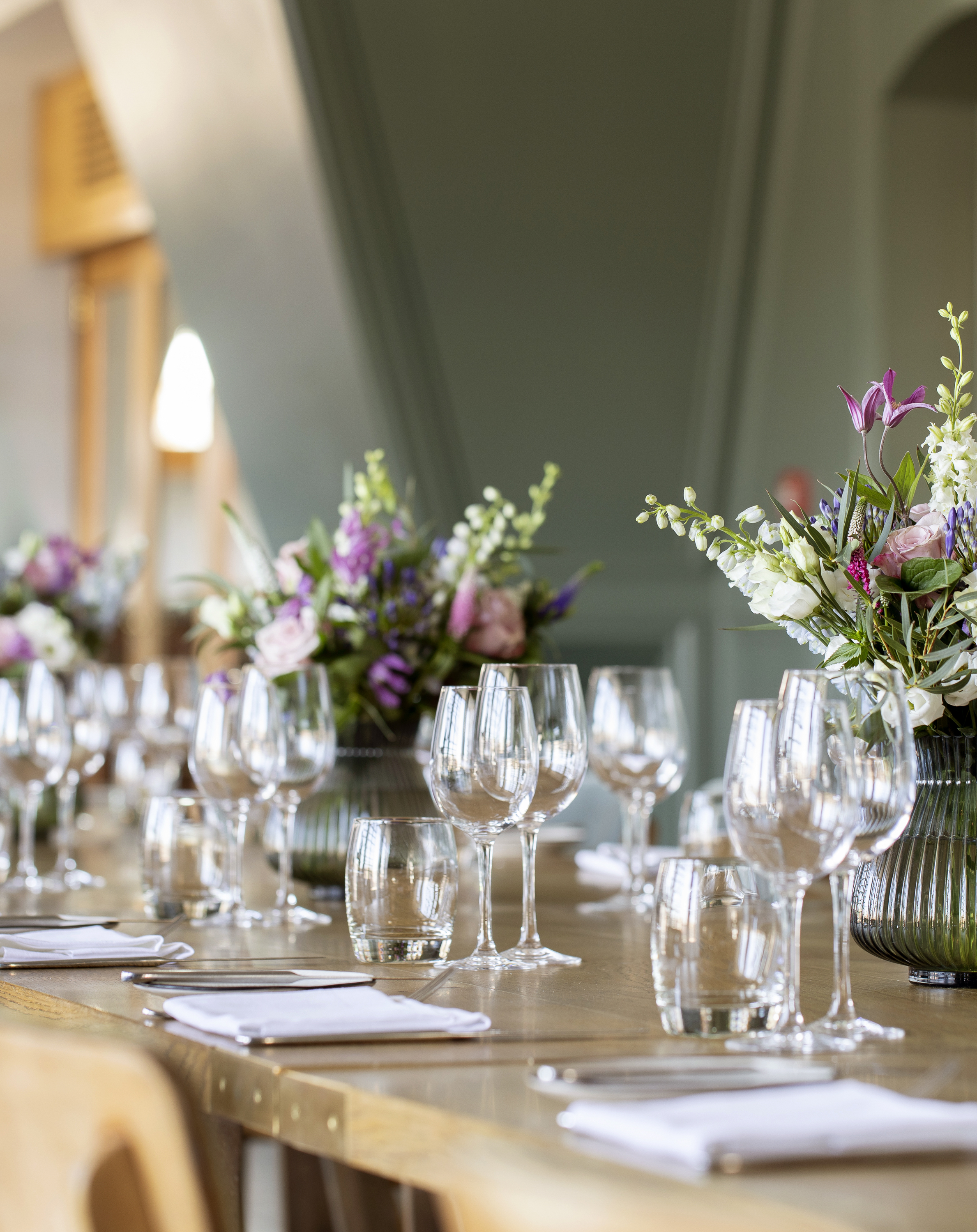 Elegant table setting with floral arrangements in The Balcony Room, ideal for upscale events.