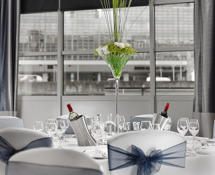 Elegant dining table with floral centerpiece at The National, DoubleTree Victoria event.