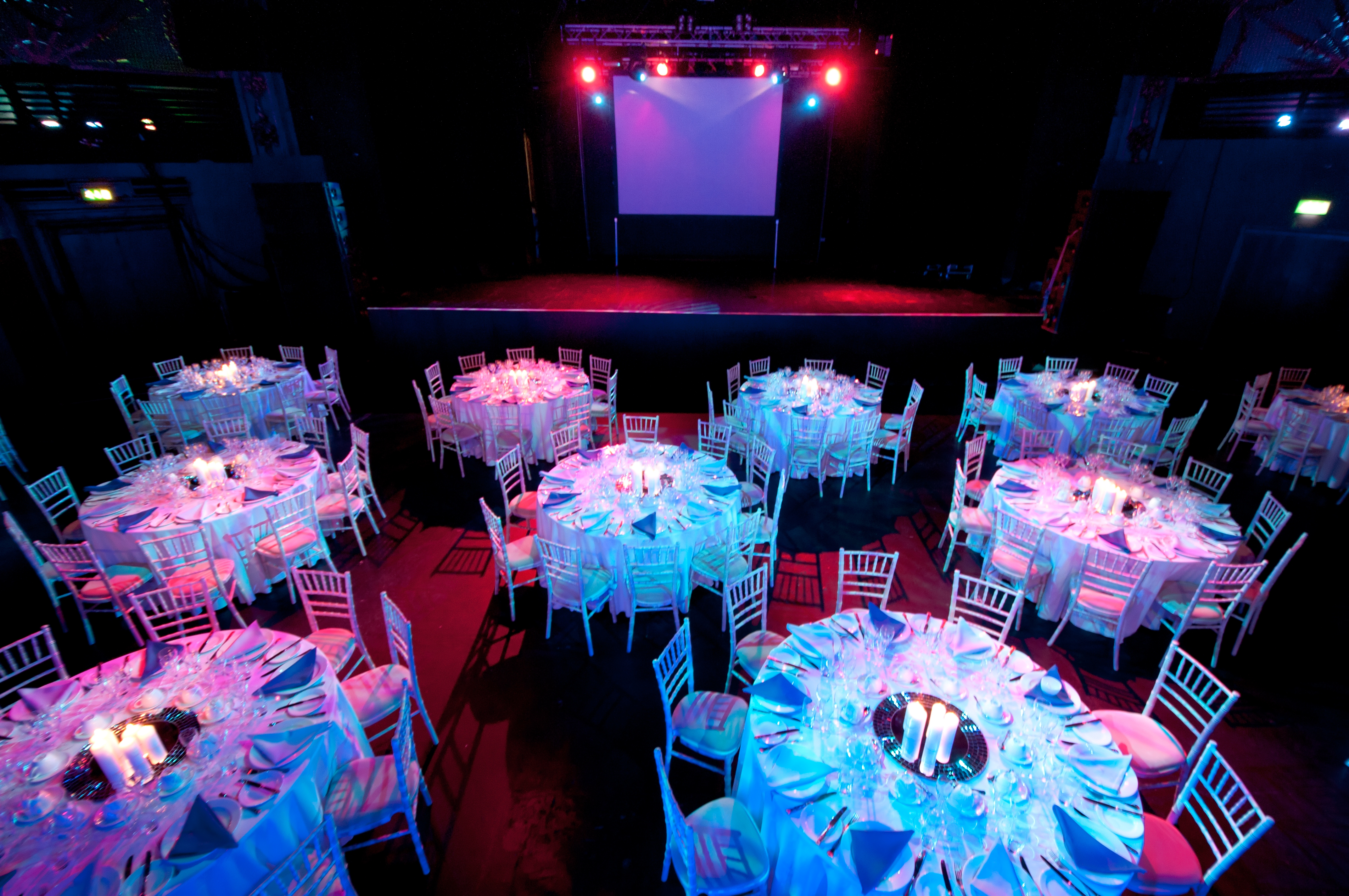 Electric Brixton event space set for formal dinner with elegant tables and vibrant ambiance.