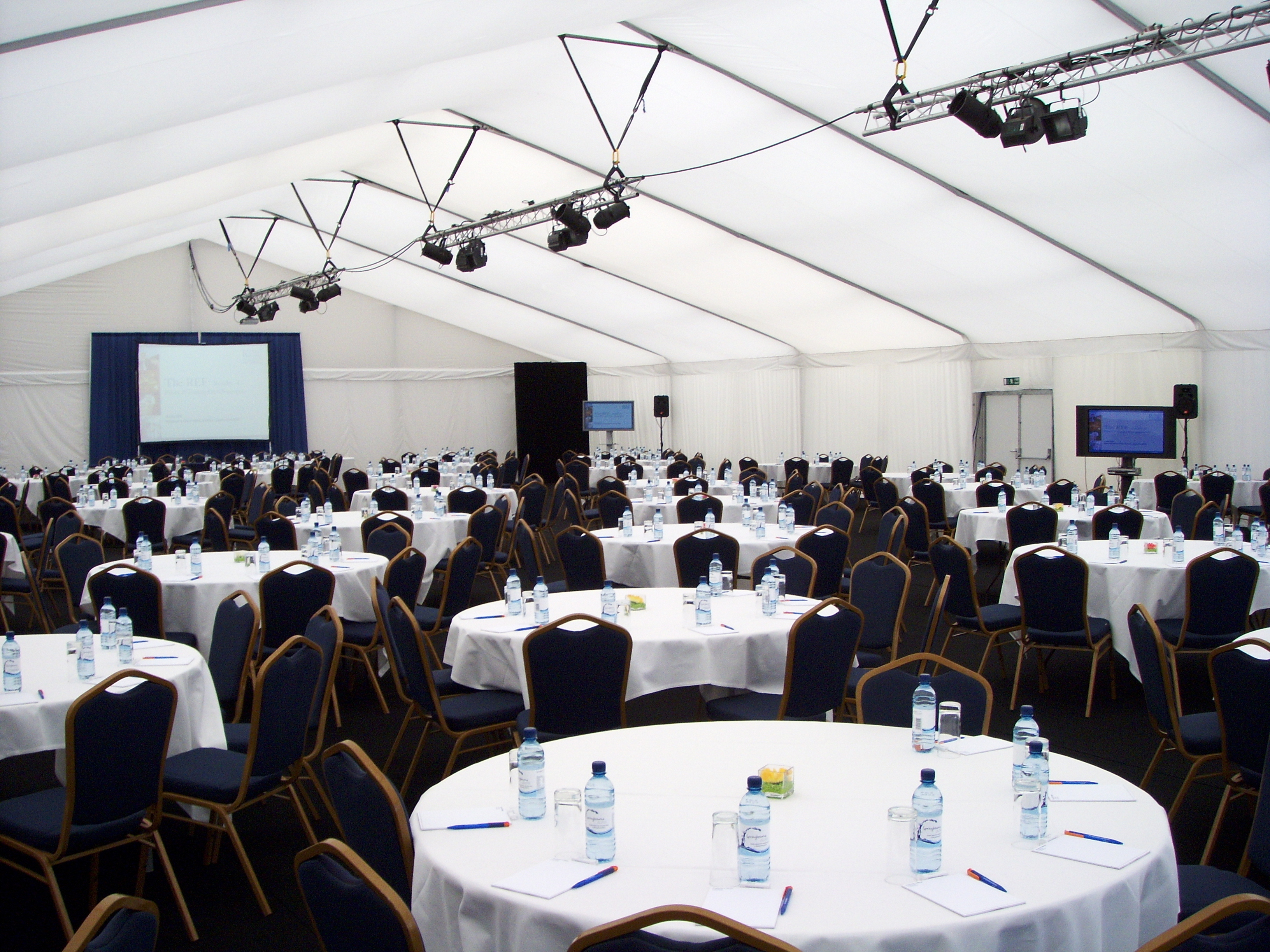 Queen's Lawn at Imperial College, set for a professional conference with round tables.