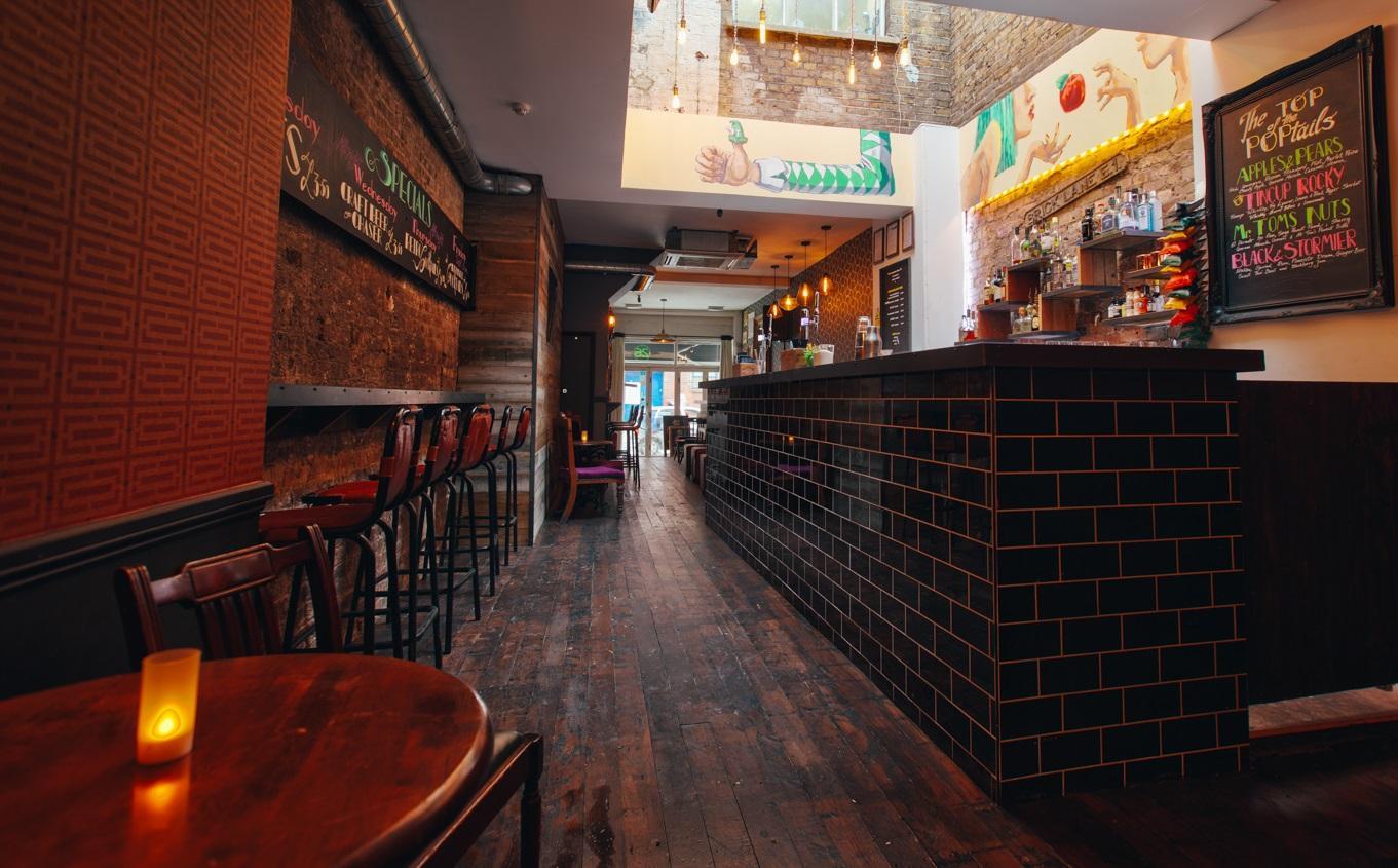 Stylish venue with wooden flooring, perfect for networking events and casual meetings.