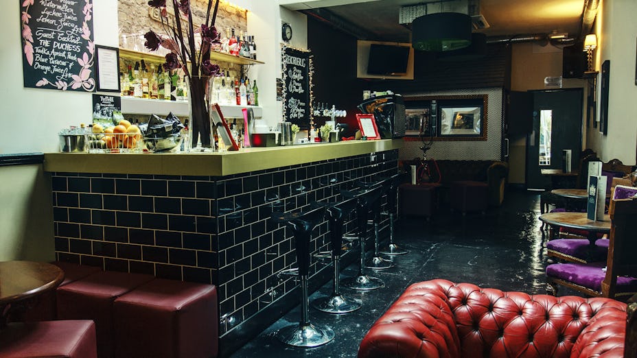 Stylish bar venue with cozy seating, perfect for cocktail receptions and networking events.