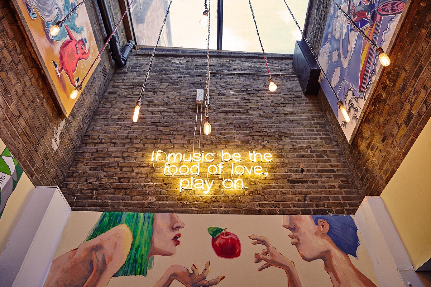 Vibrant lounge bar with neon sign, ideal for creative events and social gatherings.