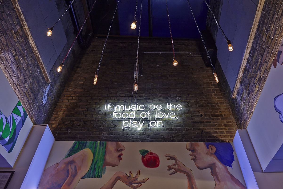 Vibrant lounge bar with neon sign, ideal for networking and social events.