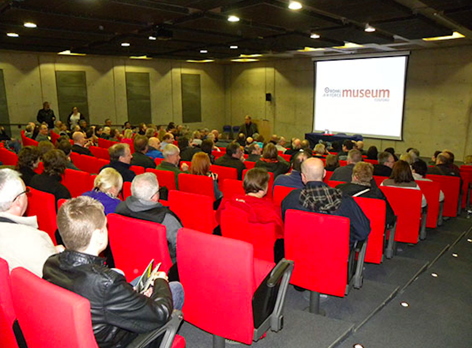 National Cold War Exhibition auditorium with red seating for conferences and presentations.