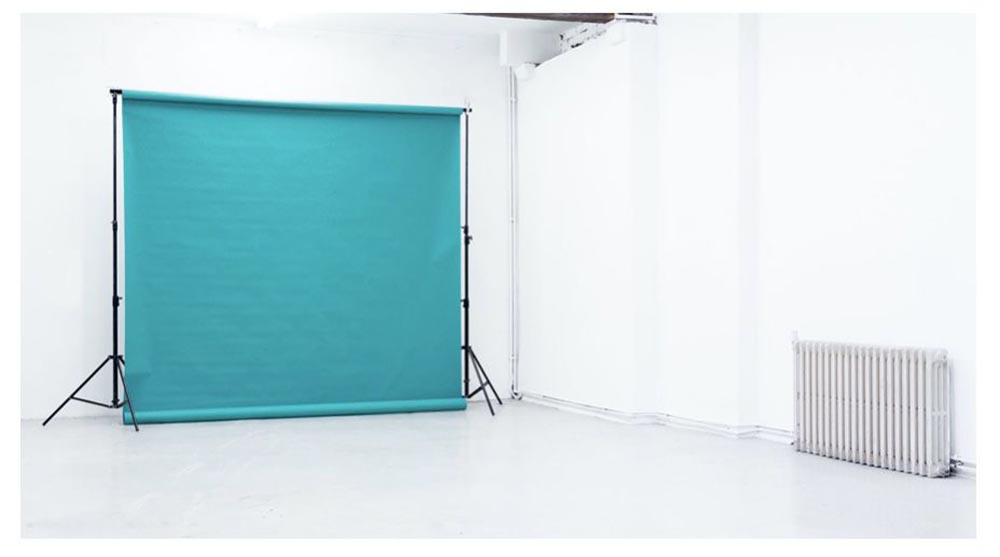 Minimalist Studio 1 at Apiary Studios with vibrant turquoise backdrop for events.
