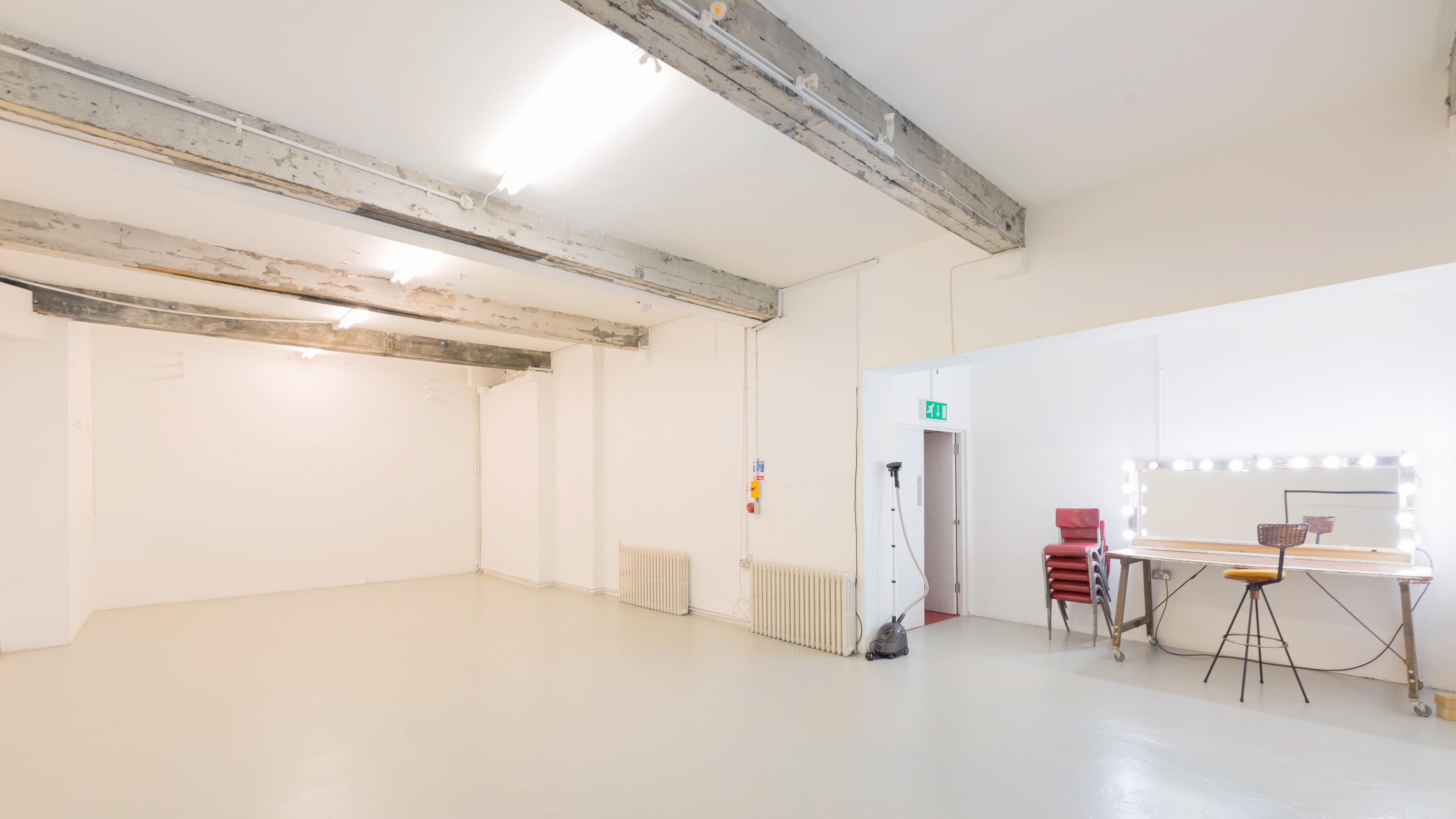 Versatile event space in Apiary Studios with minimalist design for workshops and gatherings.