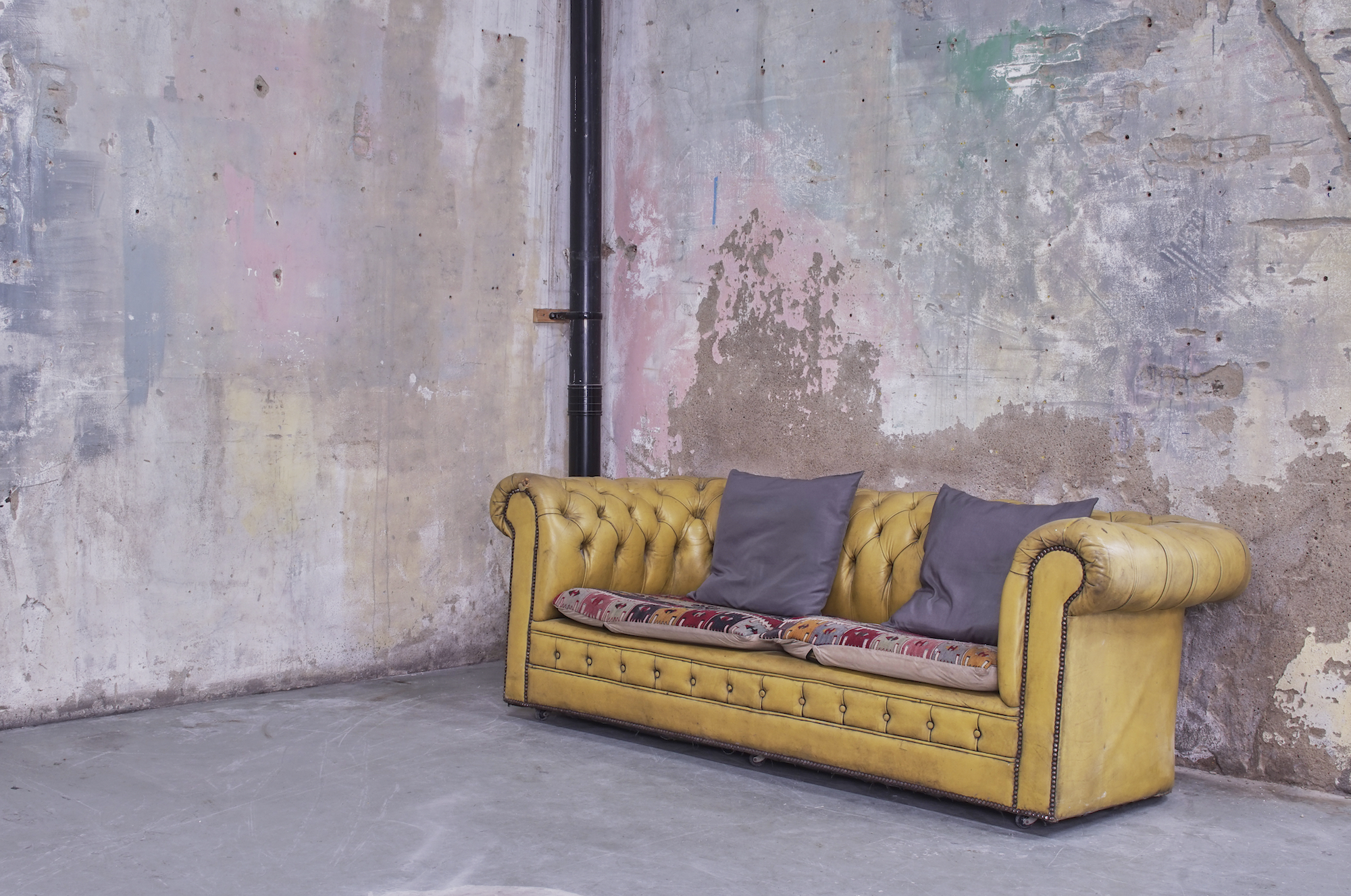 Vintage yellow leather sofa in Apiary Studios for creative events and networking.