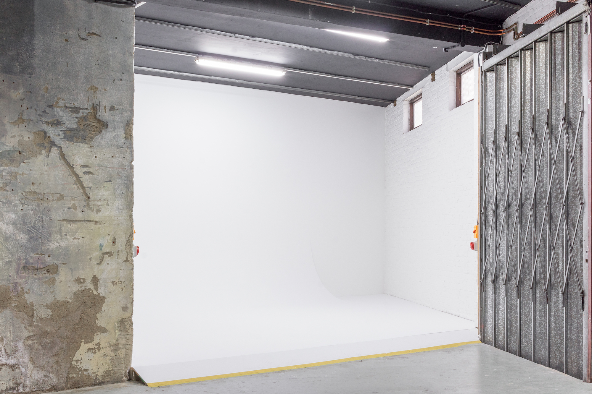 Versatile event space in Apiary Studios with minimalist backdrop for launches and workshops.