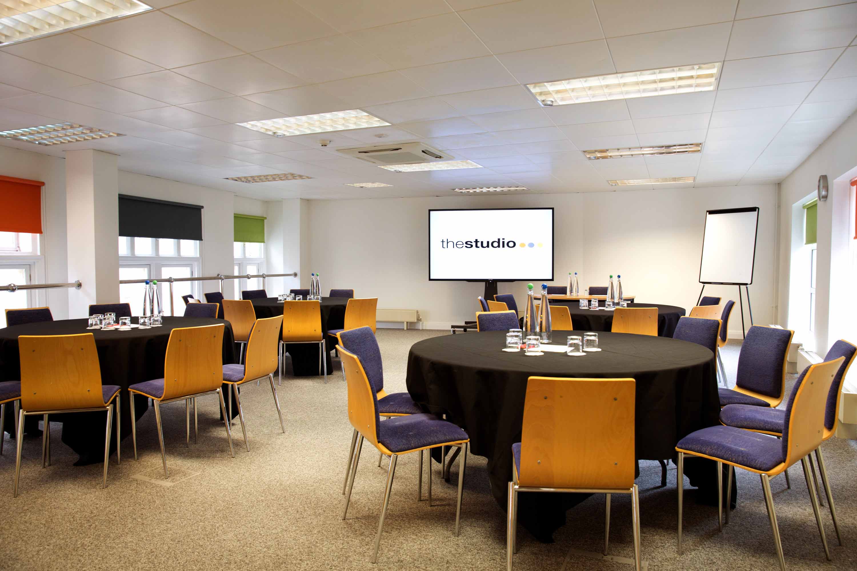 Versatile meeting space in Birmingham with round tables for workshops and corporate events.