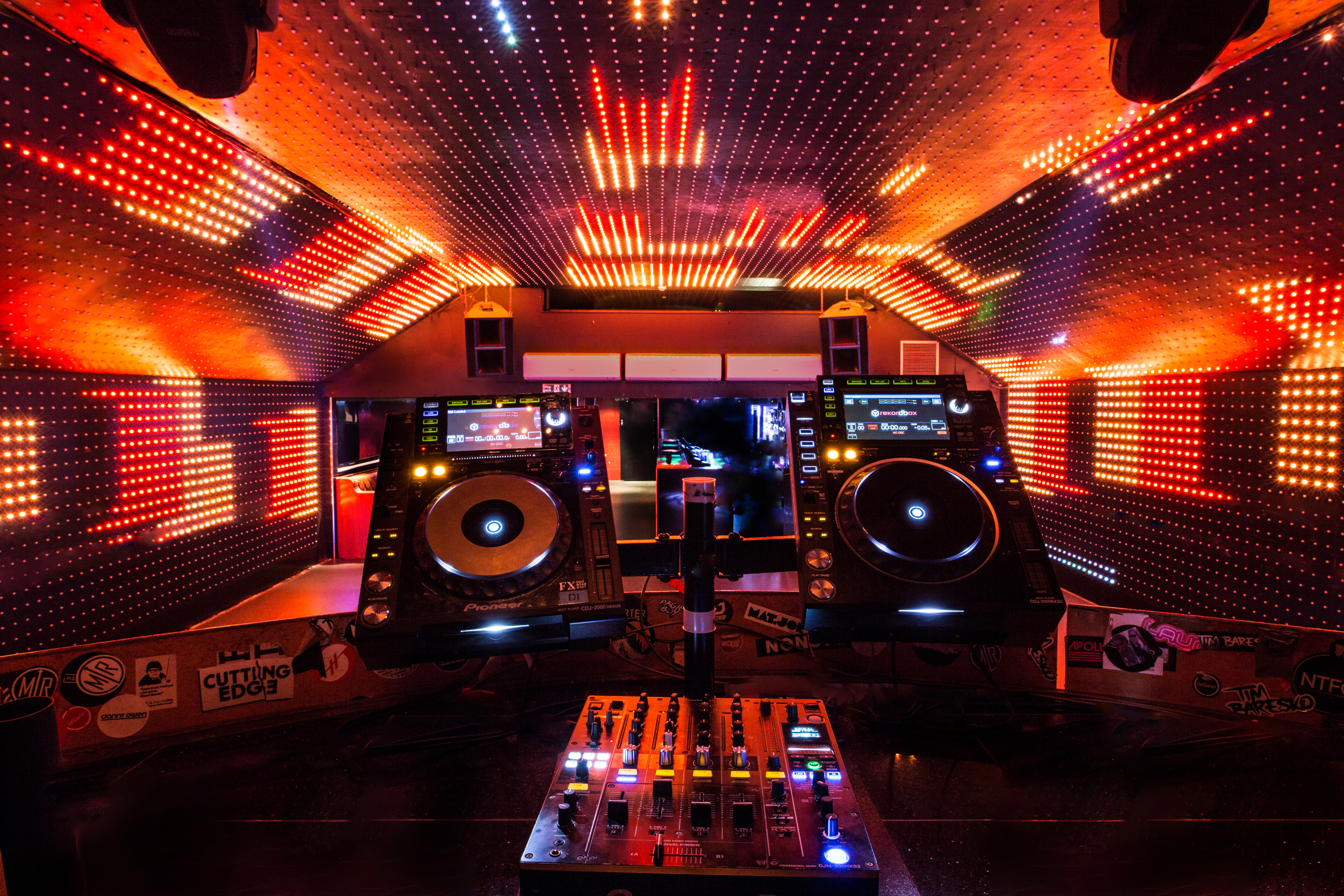 Vibrant DJ booth with LED lights at Vauxhall Arches for nightlife events and parties.