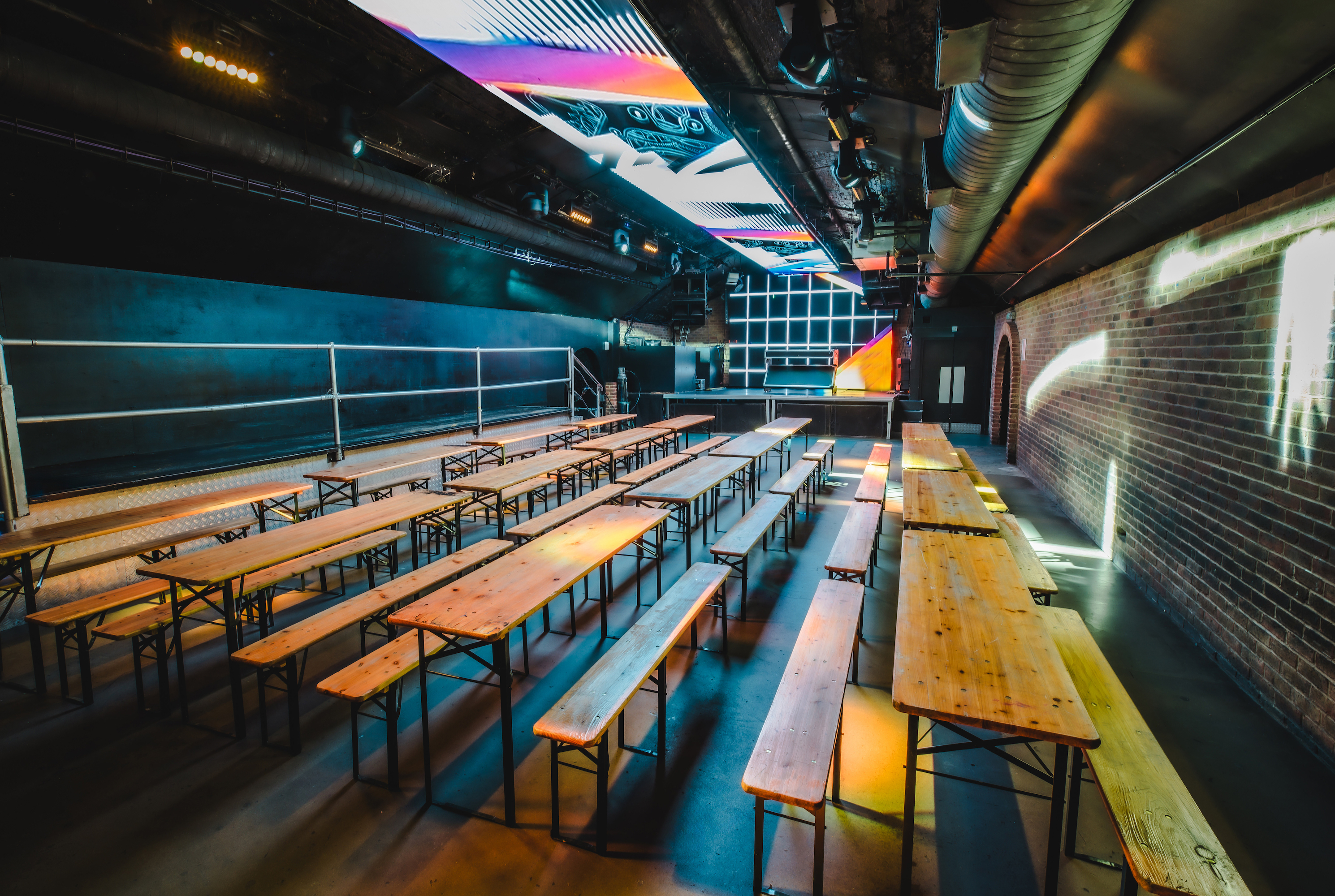 "Vauxhall Arches event space with communal tables for corporate and creative gatherings."