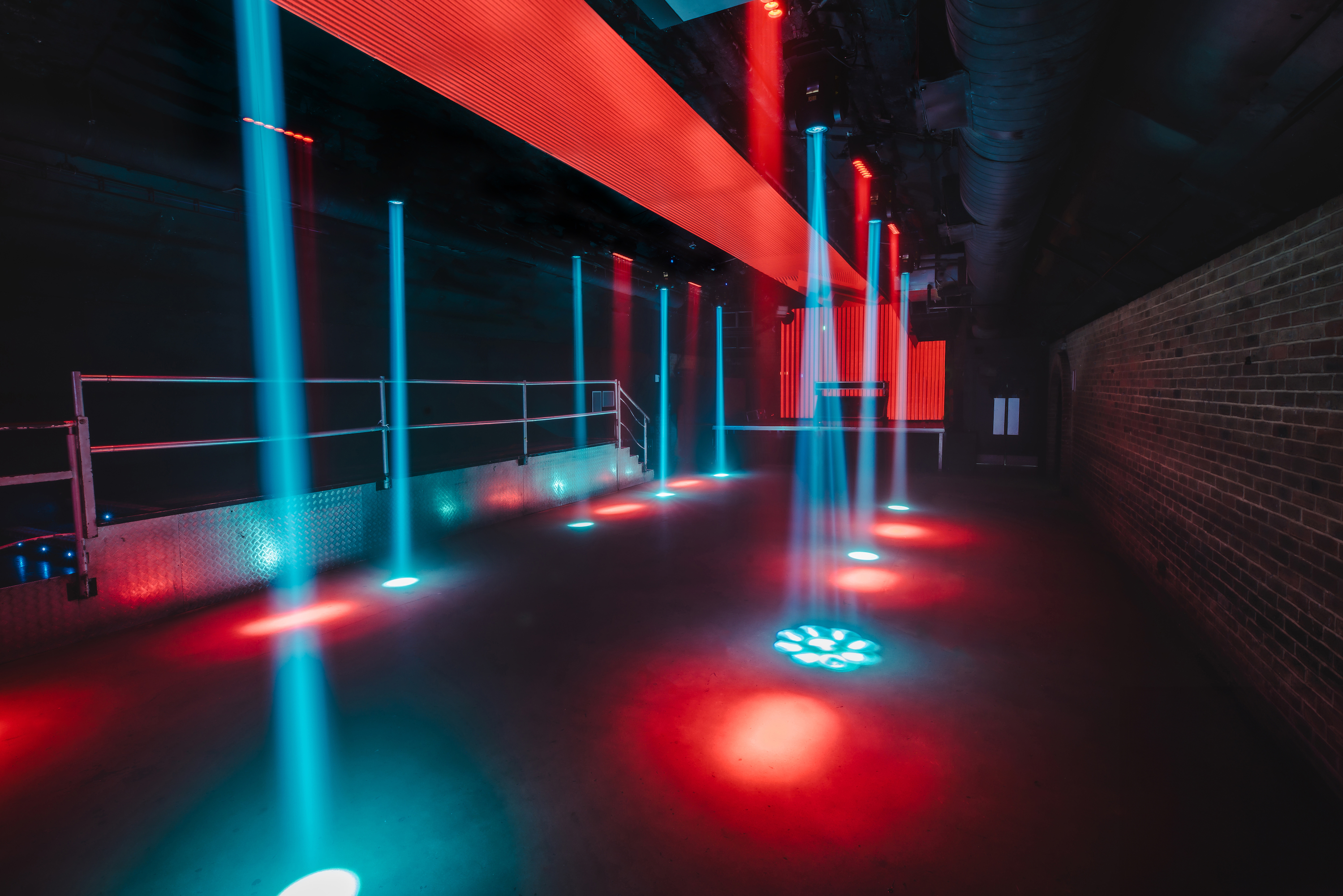 Fire in Vauxhall Arches: dynamic lighting in an industrial event space for gatherings.