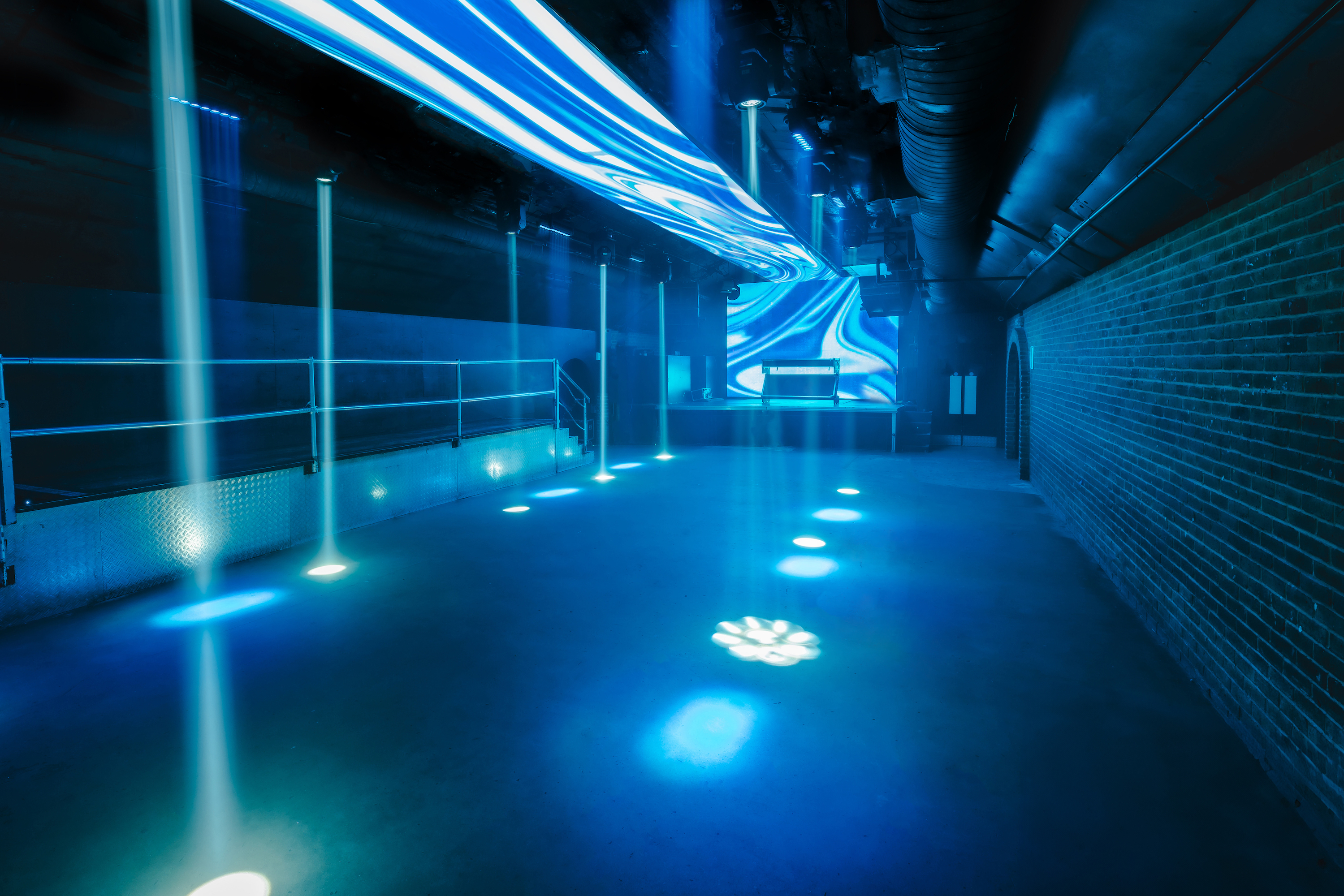 "Vauxhall Arches event space with dynamic lighting for corporate and social gatherings."