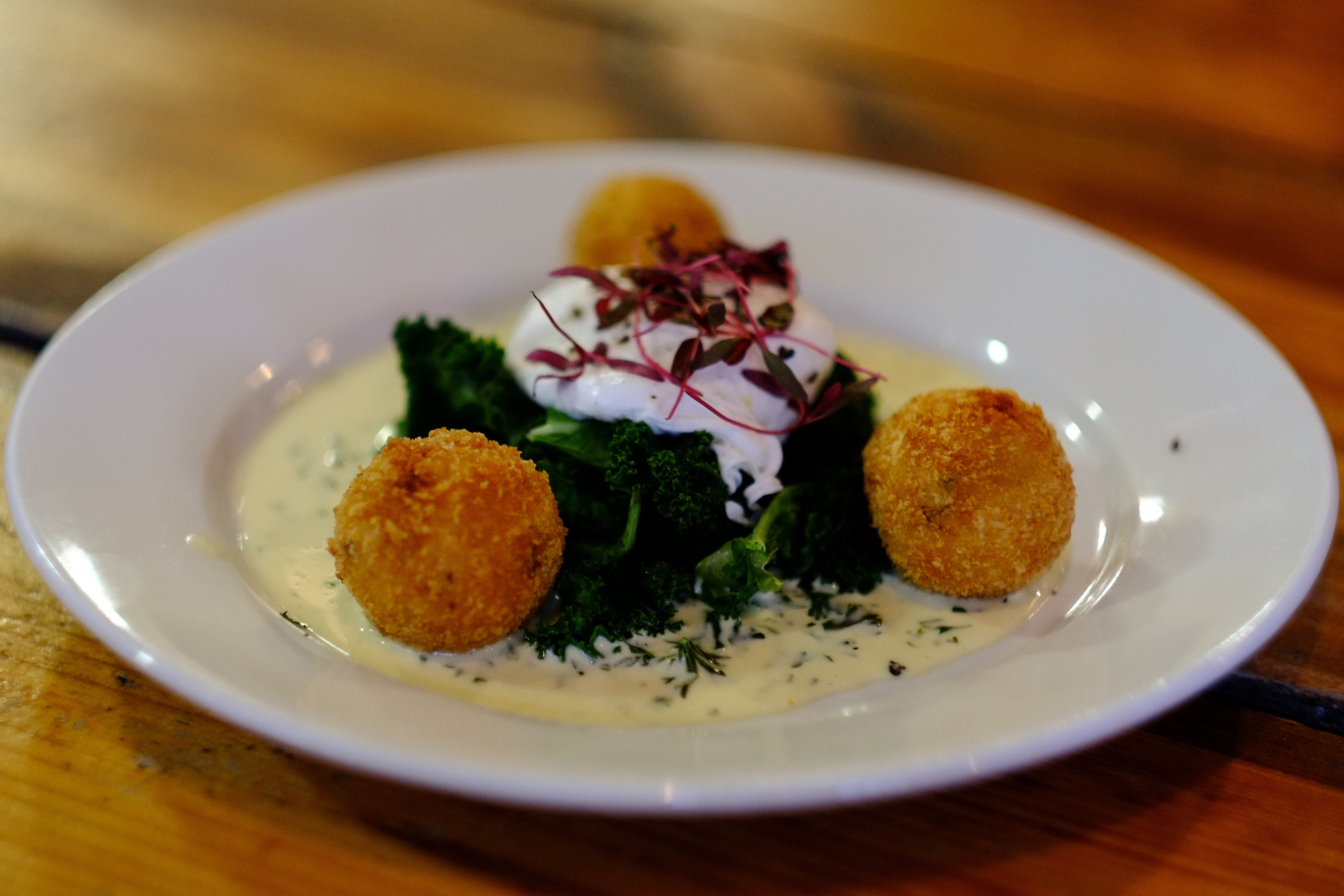 Crispy croquettes on greens at The Peoples Park Tavern for upscale events.
